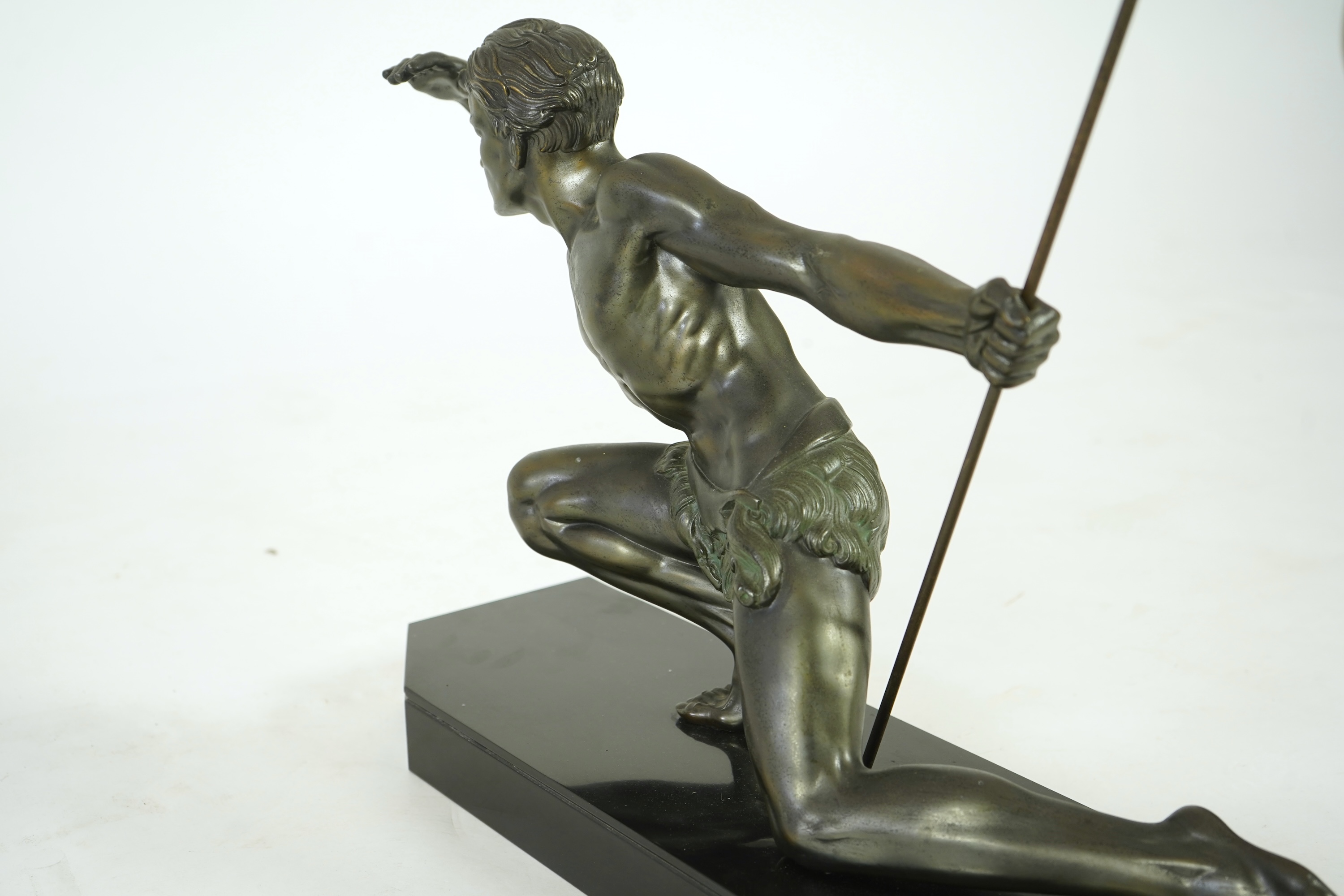 Manner of Jean de Roncourt (1869-1937) An Art Deco patinated bronze sculpture of a male hunter with spear on black marble stand